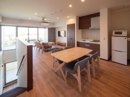 a kitchen and dining room with a table and chairs at Private condo Kourijima by Coldio Smart Resort in Nakijin