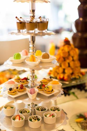 a tray of food on a buffet table with desserts at Stanford Hotel Hong Kong in Hong Kong