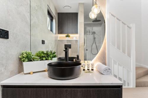 a bathroom with a black sink on a counter at Central 2-Bed Terrace House by the Harbour in Sydney