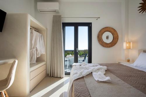 a bedroom with a bed and a balcony at Vinebranch Villa in Vourvoulos