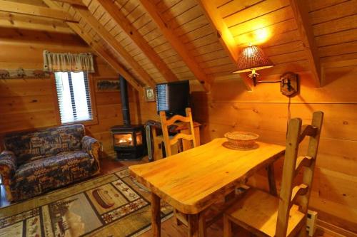 a dining room with a wooden table in a cabin at Amazing Cabin HOT tub minutes to Helen #1 in Helen