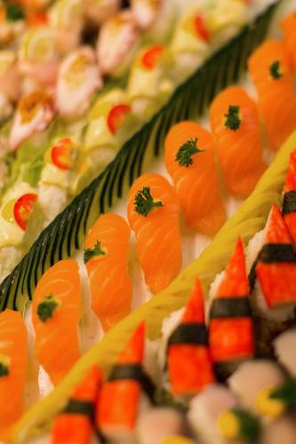 a row of food with sushi on a table at Stanford Hotel Hong Kong in Hong Kong