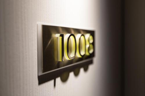 a close up of a sign on a wall at Stanford Hotel Hong Kong in Hong Kong