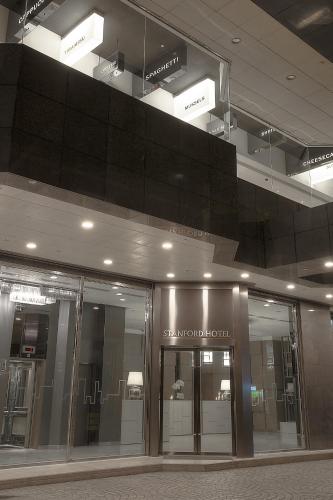 a building with glass doors and lights in a building at Stanford Hotel Hong Kong in Hong Kong