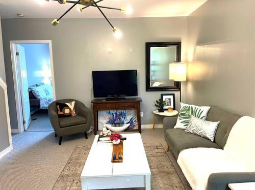 a living room with a couch and a tv at Superb Spacious Loft Old Toronto near Distillery District in Toronto