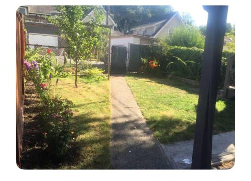 a view of a yard with a garden with a house at 4 bed upper level Kits home in Vancouver