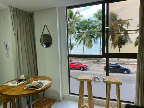a room with a table and chairs and a window at Beautiful Accommodation - #Unity Flats Cabo Branco in João Pessoa