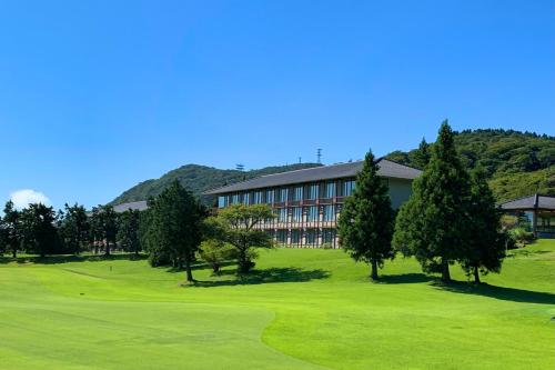 a view of a golf course with a building at Hakone Yunohana Prince Hotel in Hakone