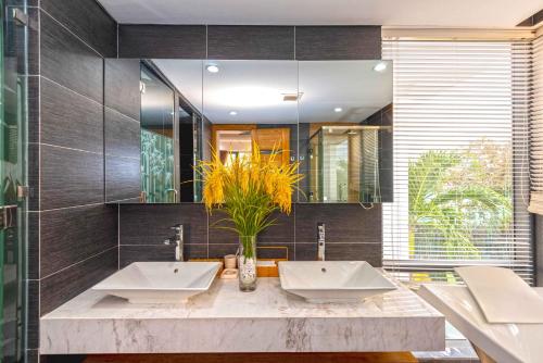 a bathroom with two sinks and a large mirror at Diamond Beach Villa Da Nang in Danang