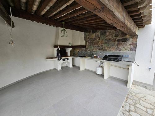 a kitchen with a counter and a stone wall at Maison Les Issambres, 3 pièces, 6 personnes - FR-1-768-79 in Saint-Peïre-sur-Mer