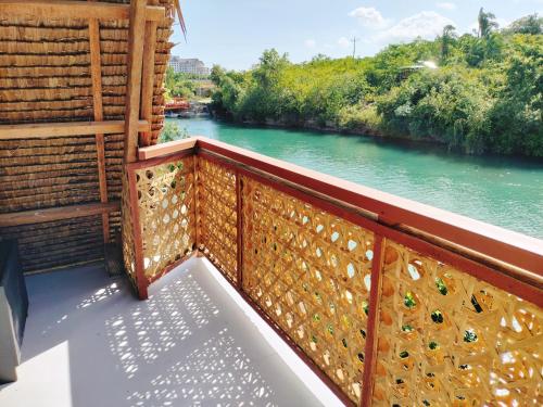 a balcony with a view of a river at Riu del Mar Hostel in Dauis