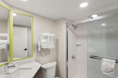 a bathroom with a shower and a toilet and a sink at Hampton Inn Bridgeport/Clarksburg in Bridgeport