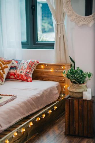 a bedroom with a bed with lights on it at MiaCasaHanoi - King Bed - Free laundry - Netflix & Rooftop Chill in Hanoi