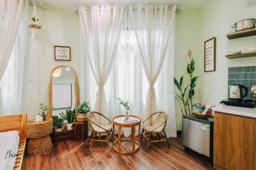 a living room with a table and chairs and a window at MiaCasaHanoi - King Bed - Free laundry - Netflix & Rooftop Chill in Hanoi