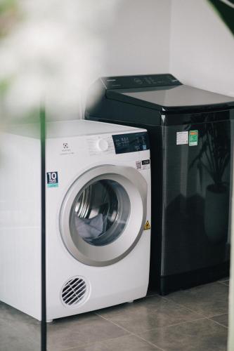 a washing machine sitting next to a dryer at MiaCasaHanoi - King Bed - Free laundry - Netflix & Rooftop Chill in Hanoi