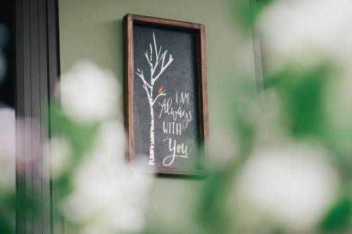 a chalkboard with a picture of a tree on it at MiaCasaHanoi - King Bed - Free laundry - Netflix & Rooftop Chill in Hanoi