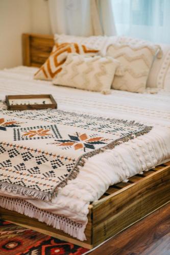 a bed with a quilt on top of it at MiaCasaHanoi - King Bed - Free laundry - Netflix & Rooftop Chill in Hanoi