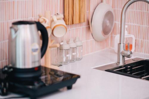 a kitchen counter with a coffee maker and a sink at MiaCasaHanoi - King Bed - Free laundry - Netflix & Rooftop Chill in Hanoi