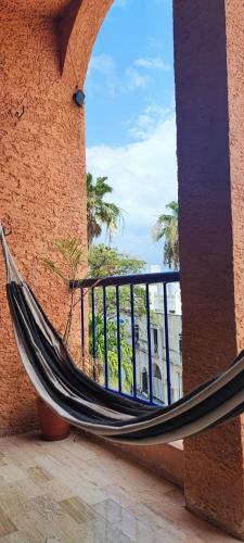 a hammock hanging from a building with a window at Villa Caribe Cancún in Cancún