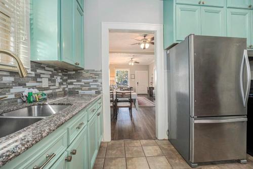 a kitchen with a stainless steel refrigerator and a dining room at Beachy Bungalow! 2BD, King Bed in Galveston