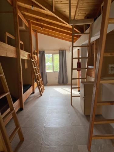 um quarto com beliches e uma escada em Hostel Verde Mondo em El Bolsón
