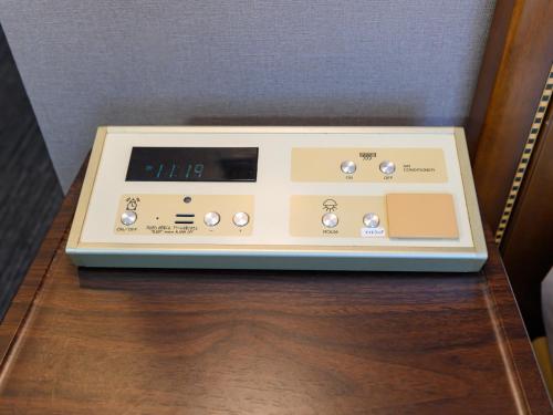 a radio sitting on top of a wooden table at Hotel Green Park Tsu in Tsu