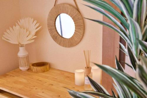 a mirror on a table with vases and a plant at NH building5F in Tokyo