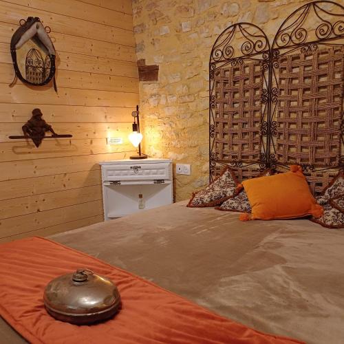 une chambre avec un lit dans une pièce aux murs en bois dans l'établissement Le Sourire du Troubadour - 8 chambres - Baignade à 300 m - Salle de jeux - Poêle à bois, à Daglan