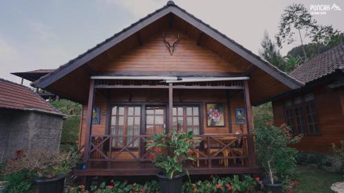 a small house with a porch and a roof at Puncak Lestari Villa Bedugul by BIJAK in Bedugul