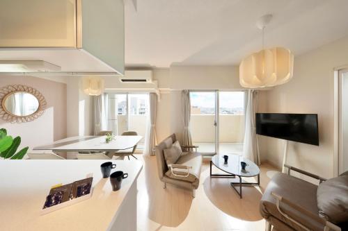 a living room with a couch and a table at City Life Miyako L'avenir in Miyako-jima