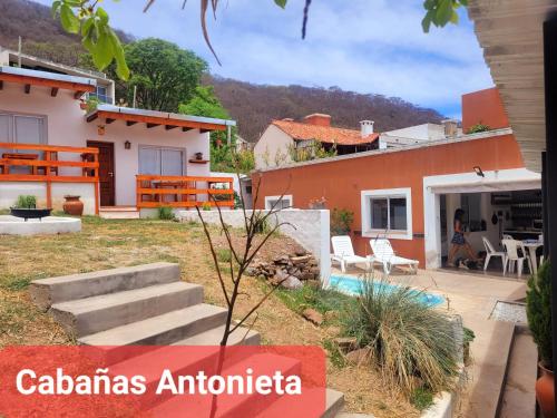 a villa with a swimming pool and a house at Cabañas Antonieta in Salta