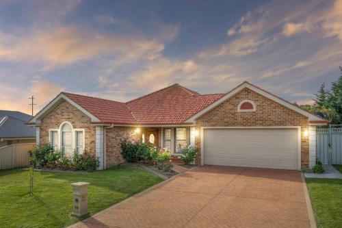 a brick house with a garage at Roselawn Manor - 5 Bedroom Entertainer in Orange