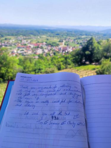 an open notebook with handwriting on it with a view at Zidanica-Vineyard Cottage Jakše in Semič