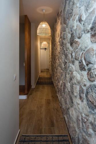 a hallway of a home with a stone wall at Bay View House in Corfu