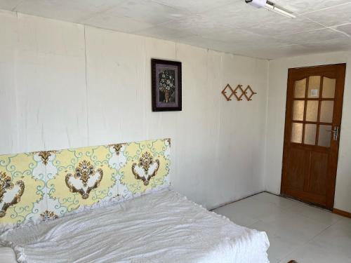 a bedroom with a bed with a pillow on it at Gana's Guest House and Tours in Ulaanbaatar