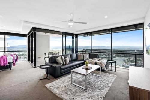 a living room with a couch and a table at Circle on Cavill - Self Contained & Privately Managed - Wow Stay in Gold Coast