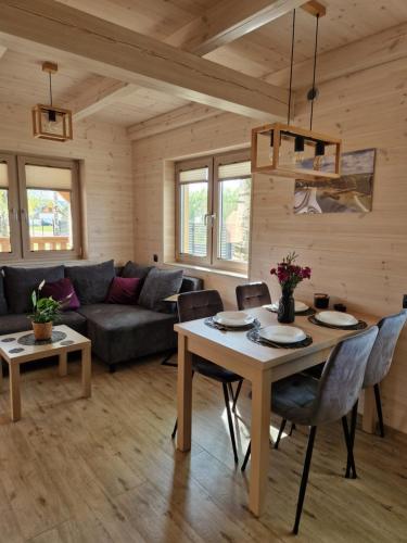 a living room with a table and a couch at Wiele Żurawi in Wiele