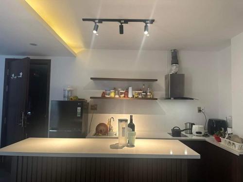 a kitchen with a counter with a bottle of wine at Clover Home Quảng Bình in Dong Hoi