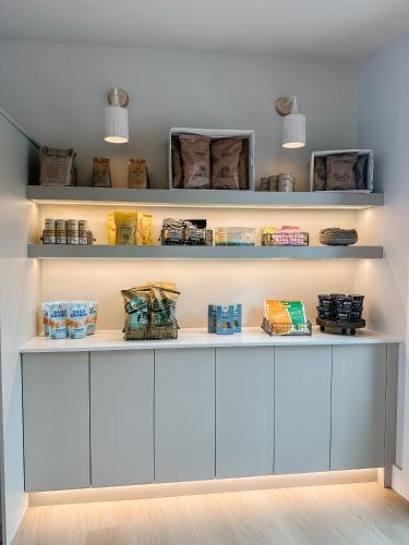 a room with white shelves with products on them at Balcomo, a Ramada by Wyndham in Penticton