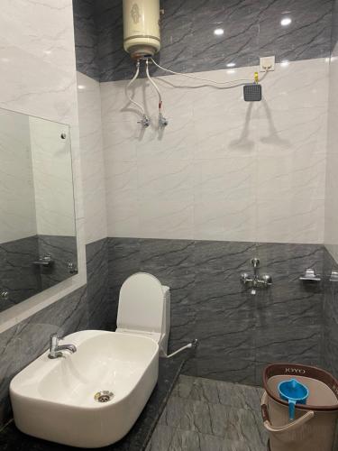 a bathroom with a toilet and a sink and a shower at Hotel ashiyana stay in Lucknow