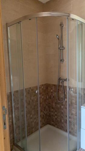 a shower with a glass enclosure in a bathroom at Residence Casa Bay Sidi Rahal in Sidi Rahal