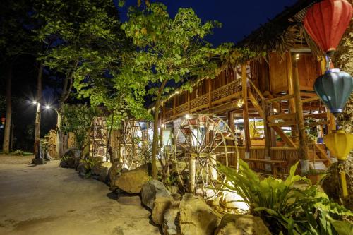 a building with a bunch of plants in front of it at Gateway Inn Puluong in Pu Luong