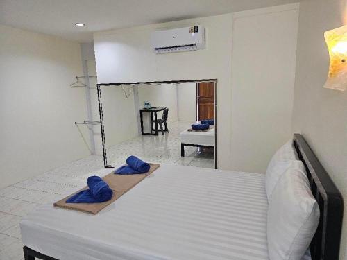 a bedroom with a bed with blue phones on it at โรงแรมเมโทร2 Metro2 in Satun