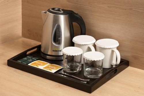 a coffee maker and cups on a tray on a table at Travelodge Myeongdong Namsan in Seoul