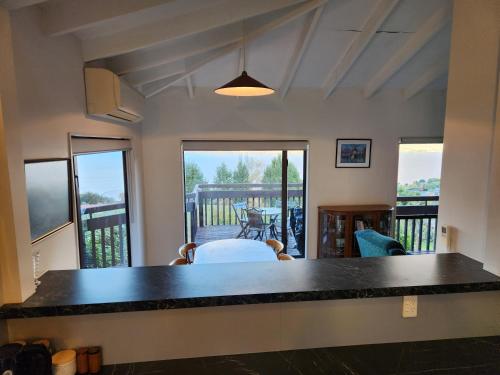 a living room with a large black counter top at Devine Hideaway - Family Rustic Kiwi Bach - Beautiful Lake Views in Queenstown