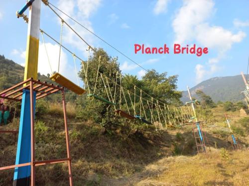 a swing set on a hill with the words plant bridge at GREEN VALLEY CAMPING & ADVENTURE in Nainital