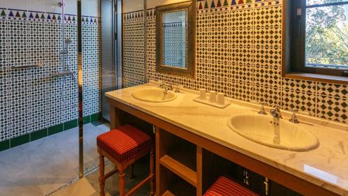 a bathroom with two sinks and a glass shower at Shima Chichukaimura in Shima