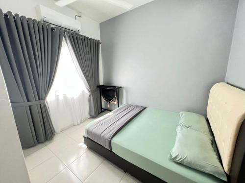 um pequeno quarto com uma cama e uma janela em SAFRA HOMESTAY PERLIS em Arau
