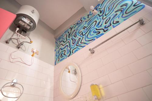 a bathroom with a sink and a mirror at malini homes Unit - 1 in Guwahati