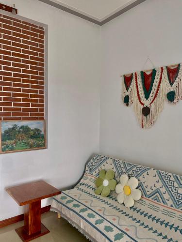 a bedroom with a bed with flowers on it at Dứa Homestay in Bao Loc